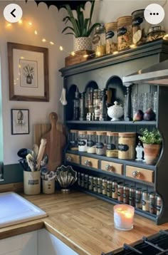 a kitchen filled with lots of pots and pans on top of a wooden counter