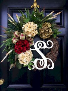 a wreath with the letter s and flowers on it