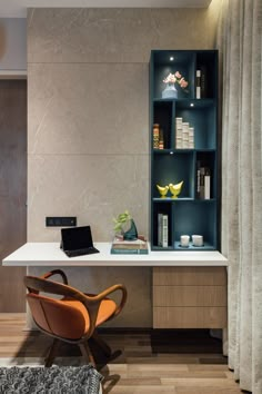 a desk with a laptop on it next to a book shelf