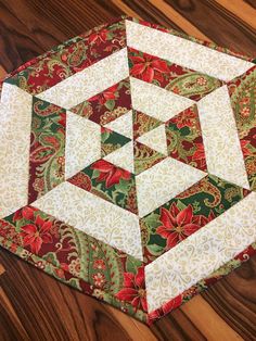 a quilted table topper on a wooden floor