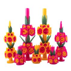 a group of vases with flowers and candles on top of each one in different colors