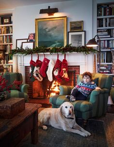 a young boy sitting in a chair next to a dog