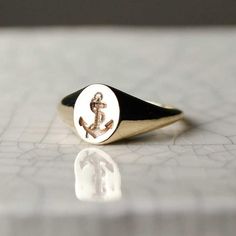 Mini Anchor Signet Ring - solid Gold  or Silver| Gold anchor ring, Gold Pinky Ring, Dainty signet Ring, Gold Signet Ring, silver anchor ring, gold signet ring, valentines giftThis Anchor signet ring makes the perfect pinky ring.  It has a minimalist androgynous quality to it– the oval face and sleek curved design are feminine in form, yet the toughness of the anchor are quite masculine.  Your anchor is someone you feel comfortable with, someone you want to share most of your experiences with, so Pinky Ring Gold, Anchor Ring, Signet Ring Silver, Anchor Rings, Gold Pinky Ring, Oval Face, Gold Signet Ring, Bespoke Jewellery, Recycled Silver