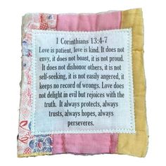 a piece of cloth with a poem on it that says love is patient, love is kind