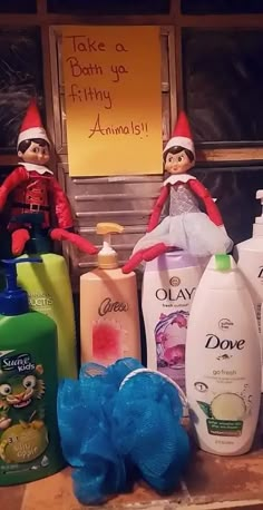 two elfs sitting next to bottles of hand sanitizers