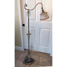 an old fashioned floor lamp in front of a door