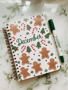 a christmas planner with ginger cookies and candy canes on it next to a marker