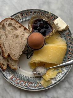 a plate with bread, cheese and an egg on it