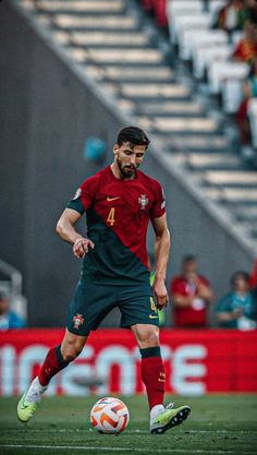 a soccer player in action on the field during a game with people watching from bleachers