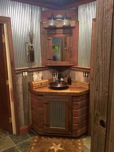 a bathroom with a sink, mirror and other items in the room that is made out of wood