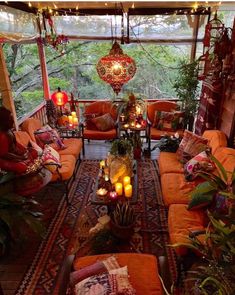 a living room filled with lots of furniture and candles on top of each couches