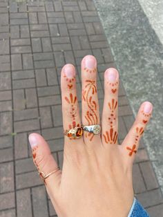 a woman's hand with hendikes painted on it and a ring in the middle