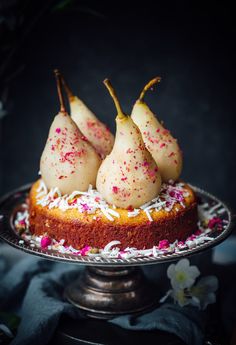 three pears on top of a cake with sprinkles