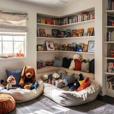 a child's bedroom with bookshelves and stuffed animals on the bed in it