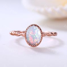 a white opal ring sitting on top of a table