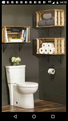 a white toilet sitting in a bathroom next to two wooden shelves filled with books and towels