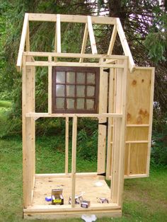 a small wooden structure with windows in it