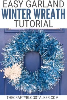 a blue door with the words easy garland winter wreath