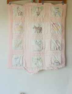 a baby quilt hanging on a clothes line