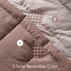 the two tone reversible color is shown on top of an unmade quilt