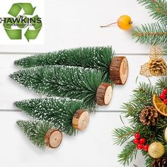 christmas decorations and pine cones are arranged on a white wooden background with the words hawks