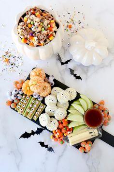 halloween treats and candy are arranged on a table