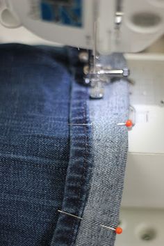 the sewing machine is working on the jeans