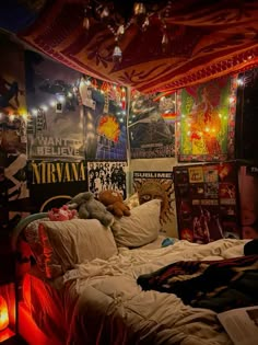 a bedroom with posters and lights on the walls