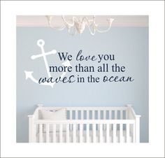 a baby's room with a wall decal that says we love you more than all the waves in the ocean