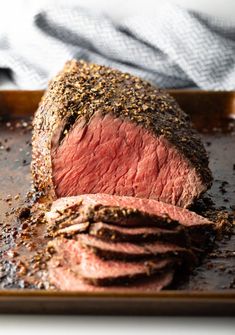 a piece of roast beef on a baking sheet with seasoning sprinkles