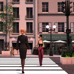 two women walking across a cross walk in front of tall buildings with windows on each side