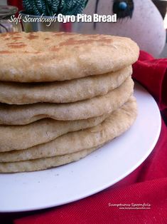 a stack of pita bread sitting on top of a white plate