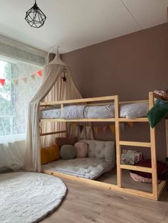 a bedroom with two bunk beds and a white rug on the floor in front of a window