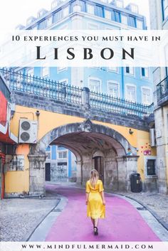 a woman walking down a street with the words 10 experiences you must have in lisbon