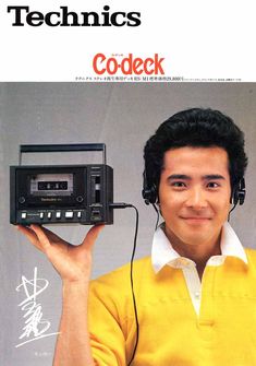 a man holding up an old radio with headphones on his ears and the words technics codeck written above it