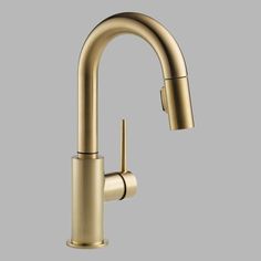 a gold faucet on a gray background