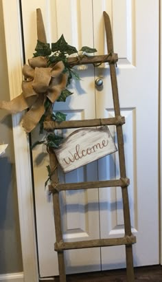 a wooden ladder with a welcome sign on it