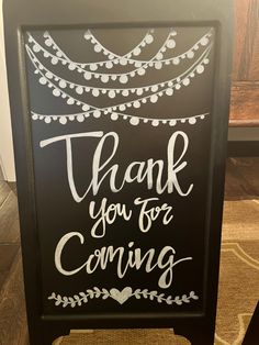 a chalkboard sign with the words thank you for coming and hanging from it's side