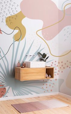 a bathroom with an artistic wallpaper and wooden flooring