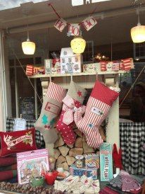 christmas stockings and other items are on display in the window