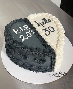 two black and white heart shaped cakes sitting on top of a table