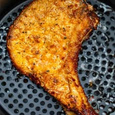 a piece of chicken is cooking in a skillet