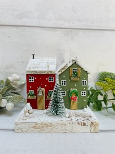 a small christmas village set up on a table