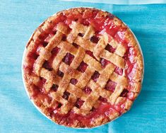 a pie with latticed crust on a blue table cloth