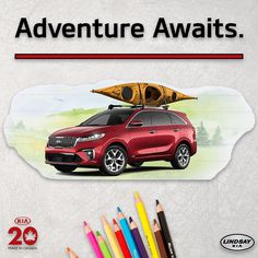 a red car with a kayak on top and two colored pencils next to it