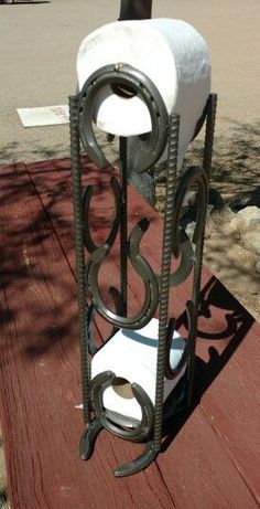 a towel holder made out of iron and wood