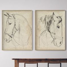 two drawings of horses are hanging on the wall next to a wooden headboard and bench