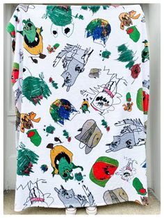 a white blanket with cartoon characters on it