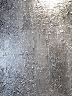 an abstract textured metal surface with white paint