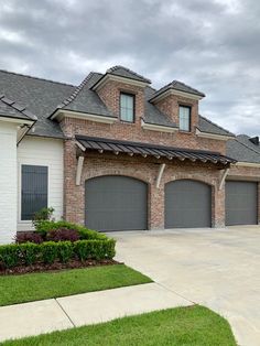 a large brick house with two garages